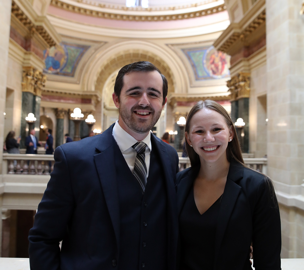 two people smile at the camera