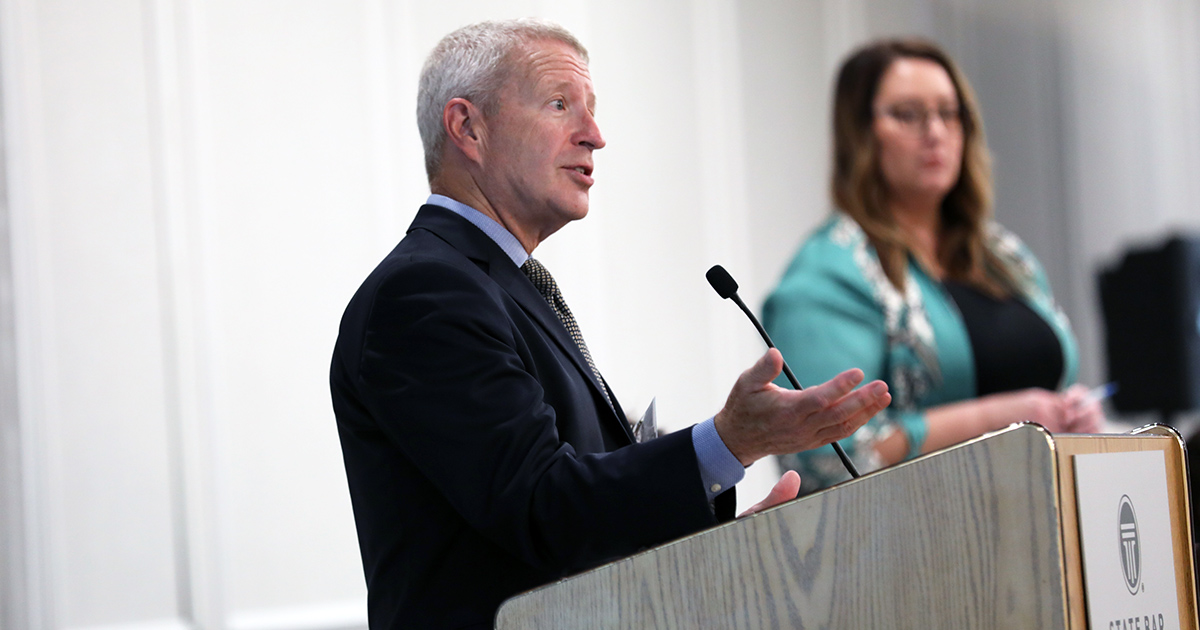 Judge Richard Sankovitz gestures while speaking at a podium