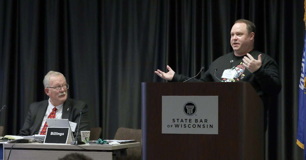 Ryan Billings gestures while speaking at a podium