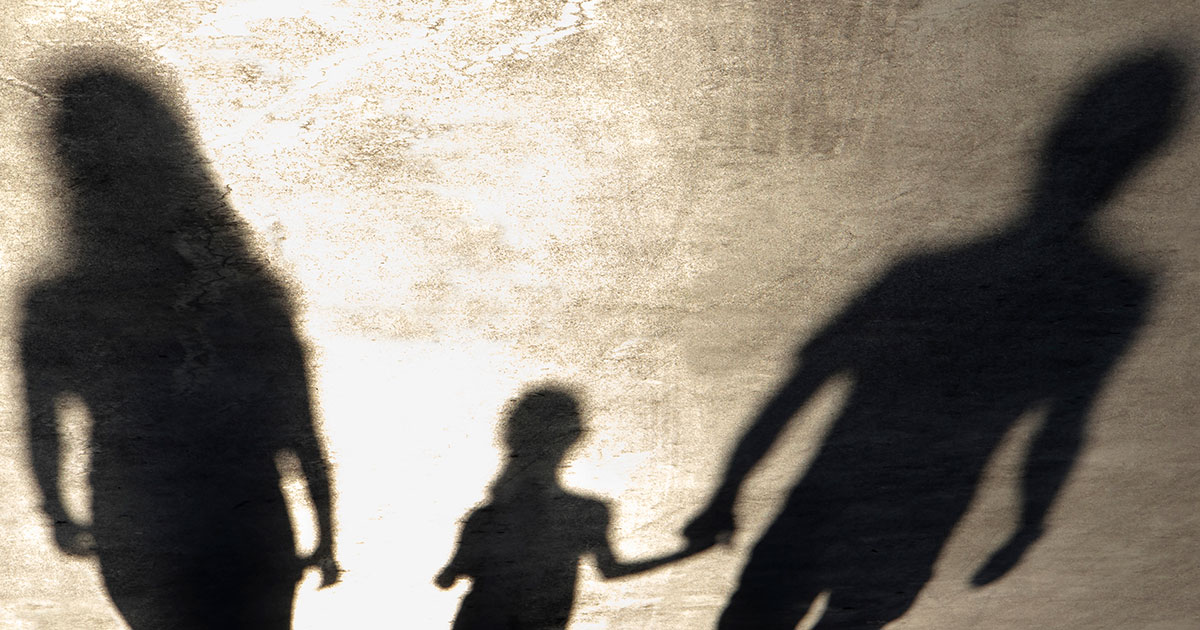 shadow of father holding hand of child but not the mother