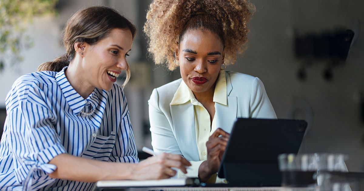 two professionals looking at a computer