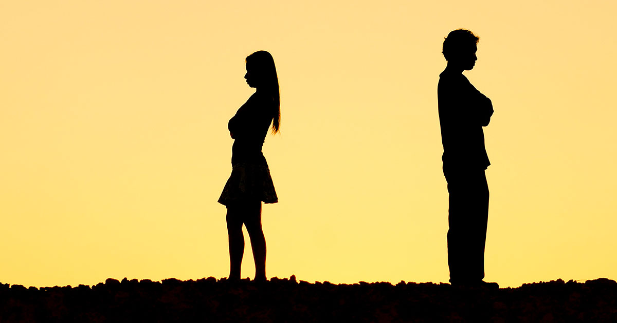 man and women stand facing away from each other