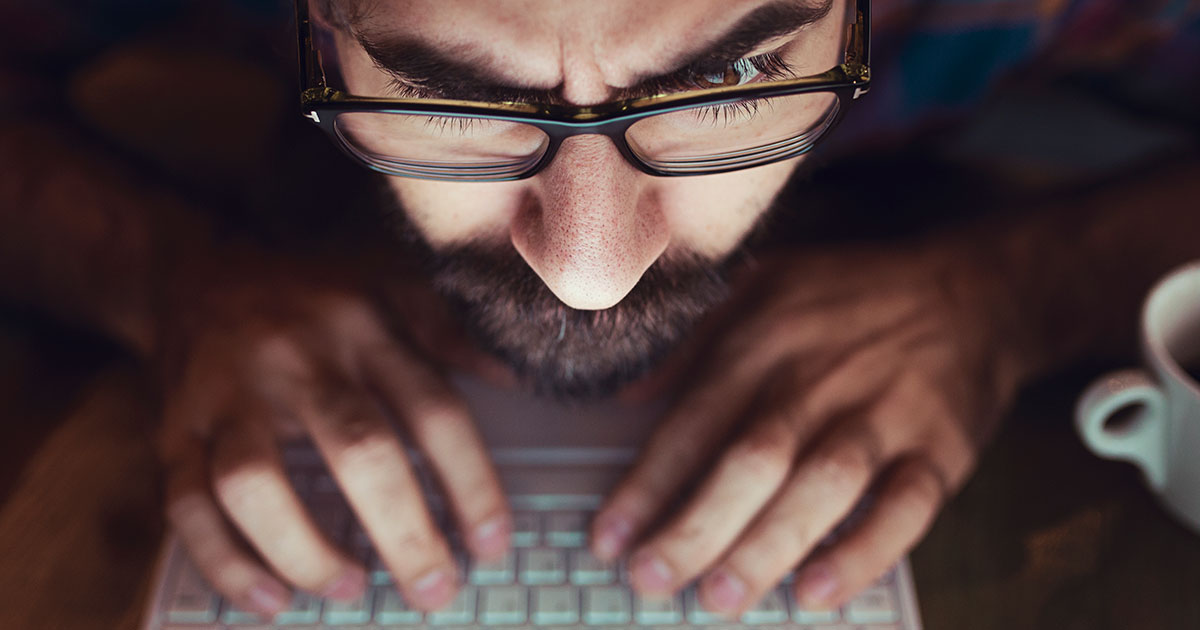 man typing at desk